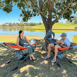 outdoor day camping by the river with portable hammock with stand